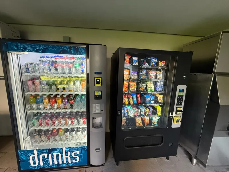 Vending service technician maintaining machine
