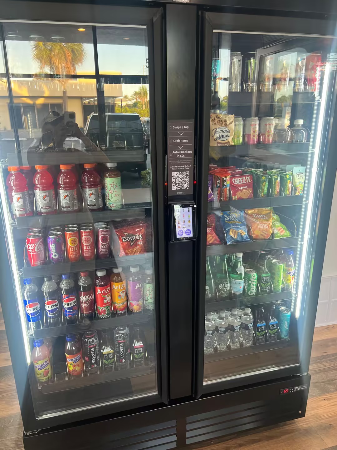 Double-door AI smart cooler stocked with beverages, snacks, and healthy options
